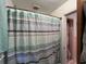 Bathroom with a blue and gray shower curtain covering the shower area at 657 Mulberry Rd., Salters, SC 29590