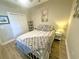 Bedroom featuring a full-size bed, neutral walls, and a view of the closet. Well-lit by natural light at 700 Pickering Dr. # 103, Murrells Inlet, SC 29576