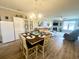 Well-lit dining area with a table set for six, open to the living room and kitchen at 700 Pickering Dr. # 103, Murrells Inlet, SC 29576