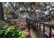 A large backyard with a gazebo and a black metal fence in front of a wooded area at 762 Wraggs Ferry Rd., Georgetown, SC 29440