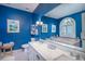Bright primary bathroom with a double sink vanity, blue walls and a large mirror and a soaking tub at 762 Wraggs Ferry Rd., Georgetown, SC 29440