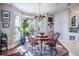 Bright dining room with round table, chandelier, large windows overlooking the backyard at 762 Wraggs Ferry Rd., Georgetown, SC 29440