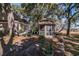 An exterior view shows the home with a gazebo, lush landscaping, and mature trees at 762 Wraggs Ferry Rd., Georgetown, SC 29440