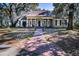 Inviting traditional home with a brick walkway, lovely lawn, and stately trees draped with Spanish moss at 762 Wraggs Ferry Rd., Georgetown, SC 29440