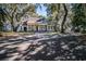 Inviting front exterior of a traditional home with a columned porch, surrounded by mature trees at 762 Wraggs Ferry Rd., Georgetown, SC 29440