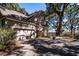 A two-car garage and a large tree with Spanish moss in the backyard at 762 Wraggs Ferry Rd., Georgetown, SC 29440