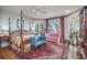 Cozy main bedroom with a four-poster bed, sitting area, and natural light at 762 Wraggs Ferry Rd., Georgetown, SC 29440