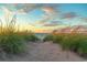 Pathway leads to a picturesque beach with tranquil ocean views and a beautiful sky at 850 Fairway Dr. # 1003Ee, Longs, SC 29568