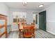 Charming dining area featuring a wood table, four chairs, and a view of the outside at 850 Fairway Dr. # 1003Ee, Longs, SC 29568