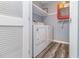 Convenient laundry area with a white washer and dryer set, shelves, and clean interior design at 850 Fairway Dr. # 1003Ee, Longs, SC 29568