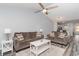 An inviting living room with neutral tones, ceiling fan, and comfortable couches provides ample seating space at 850 Fairway Dr. # 1003Ee, Longs, SC 29568