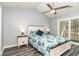Bright main bedroom featuring a ceiling fan, patio access, and coastal-themed bedding for a tranquil retreat at 850 Fairway Dr. # 1003Ee, Longs, SC 29568