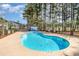 Refreshing community pool surrounded by mature trees, offering a perfect oasis for relaxation and recreation at 850 Fairway Dr. # 1003Ee, Longs, SC 29568