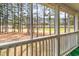 Relaxing screened porch overlooking a picturesque landscape of lush trees and a grassy lawn at 850 Fairway Dr. # 1003Ee, Longs, SC 29568