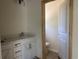 Bathroom featuring dual vanity, stone countertop, and wooden trimmed doorway at 8545 Pee Dee Hwy., Conway, SC 29527