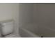 View of toilet and bathtub in all-white bathroom at 8545 Pee Dee Hwy., Conway, SC 29527