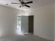 A bedroom has a ceiling fan, window, and open door at 8545 Pee Dee Hwy., Conway, SC 29527