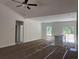 Open-concept living area featuring natural light, ceiling fan, and neutral walls awaiting the final flooring installation at 8545 Pee Dee Hwy., Conway, SC 29527