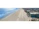 Wide aerial view of the beach, ocean, and condo community on a sunny day at 900 N Waccamaw Dr. # 203, Garden City Beach, SC 29576