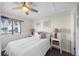 Cozy bedroom with a ceiling fan, queen size bed, nautical decor and wainscoting at 900 N Waccamaw Dr. # 203, Garden City Beach, SC 29576