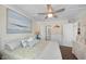 Inviting bedroom with beachy accents, a ceiling fan, and adjacent bathroom access at 900 N Waccamaw Dr. # 203, Garden City Beach, SC 29576