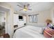 Bright bedroom with a ceiling fan, queen size bed, built in storage, and nautical decor at 900 N Waccamaw Dr. # 203, Garden City Beach, SC 29576