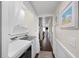 Bright hallway with a laundry area and decor leading to other rooms in the house at 900 N Waccamaw Dr. # 203, Garden City Beach, SC 29576