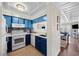 Kitchen with blue cabinets and appliances near the living room at 900 N Waccamaw Dr. # 203, Garden City Beach, SC 29576