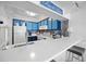 Kitchen with blue cabinets, white countertop, and bar stool seating at 900 N Waccamaw Dr. # 203, Garden City Beach, SC 29576