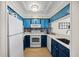 Kitchen with blue cabinets and appliances at 900 N Waccamaw Dr. # 203, Garden City Beach, SC 29576