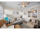 Bright sunroom featuring nautical decor, including pillows with shell designs, and a ceiling fan at 900 N Waccamaw Dr. # 203, Garden City Beach, SC 29576