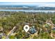 Aerial view of a home nestled among lush trees, near a picturesque river, and close to the ocean at 9100 Sw Fountain St., Calabash, NC 28467