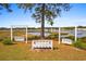 Inviting backyard with waterfront views, a bench swing, and lush greenery at 9100 Sw Fountain St., Calabash, NC 28467