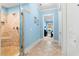 Light-blue bathroom with decorative tile flooring that features a stone pebble floor in the glass shower at 9100 Sw Fountain St., Calabash, NC 28467
