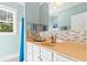 Bright bathroom with a tan counter, white cabinets and a mosaic tile backsplash at 9100 Sw Fountain St., Calabash, NC 28467