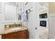 Elegant powder room featuring a granite countertop vanity and stylish white wainscoting at 9100 Sw Fountain St., Calabash, NC 28467