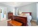 Light-blue bedroom with a queen bed, hardwood dresser, and two windows offering natural light at 9100 Sw Fountain St., Calabash, NC 28467