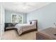 Cozy bedroom with a bed, dark furniture, and natural light coming through two windows at 9100 Sw Fountain St., Calabash, NC 28467