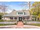 Charming community clubhouse with a white picket fence and manicured landscaping at 9100 Sw Fountain St., Calabash, NC 28467