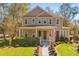 Charming two-story home boasts a welcoming front porch and manicured landscaping, complete with the American flag at 9100 Sw Fountain St., Calabash, NC 28467