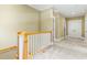Hallway with white wainscoting leads to a room with neutral walls and white-trimmed doors at 9100 Sw Fountain St., Calabash, NC 28467