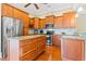 Spacious kitchen with stainless steel appliances, granite countertops, custom cabinets, and hardwood floors at 9100 Sw Fountain St., Calabash, NC 28467