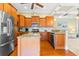 Well-equipped kitchen featuring wood cabinetry, granite counters, stainless steel appliances, and a central island at 9100 Sw Fountain St., Calabash, NC 28467