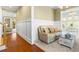 Comfortable living room featuring neutral tones, hardwood floors, and stylish wainscoting at 9100 Sw Fountain St., Calabash, NC 28467