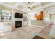 Open-concept living room with fireplace, built-in shelving, and easy access to the kitchen at 9100 Sw Fountain St., Calabash, NC 28467
