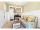 Bright living room featuring neutral tones, a cozy sofa, and stylish wainscoting at 9100 Sw Fountain St., Calabash, NC 28467