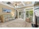 Bright living room featuring neutral tones, a coffered ceiling, a fireplace, and sliding doors at 9100 Sw Fountain St., Calabash, NC 28467
