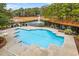 Aerial view of a large pool with well-maintained landscaping and surrounding trees at 9100 Sw Fountain St., Calabash, NC 28467