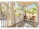 Cozy screened porch with outdoor chairs and a view of the peaceful surroundings at 9100 Sw Fountain St., Calabash, NC 28467