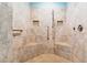 Walk-in shower featuring tan tile, mosaic accents, and a pebble floor with built-in shower benches at 9100 Sw Fountain St., Calabash, NC 28467